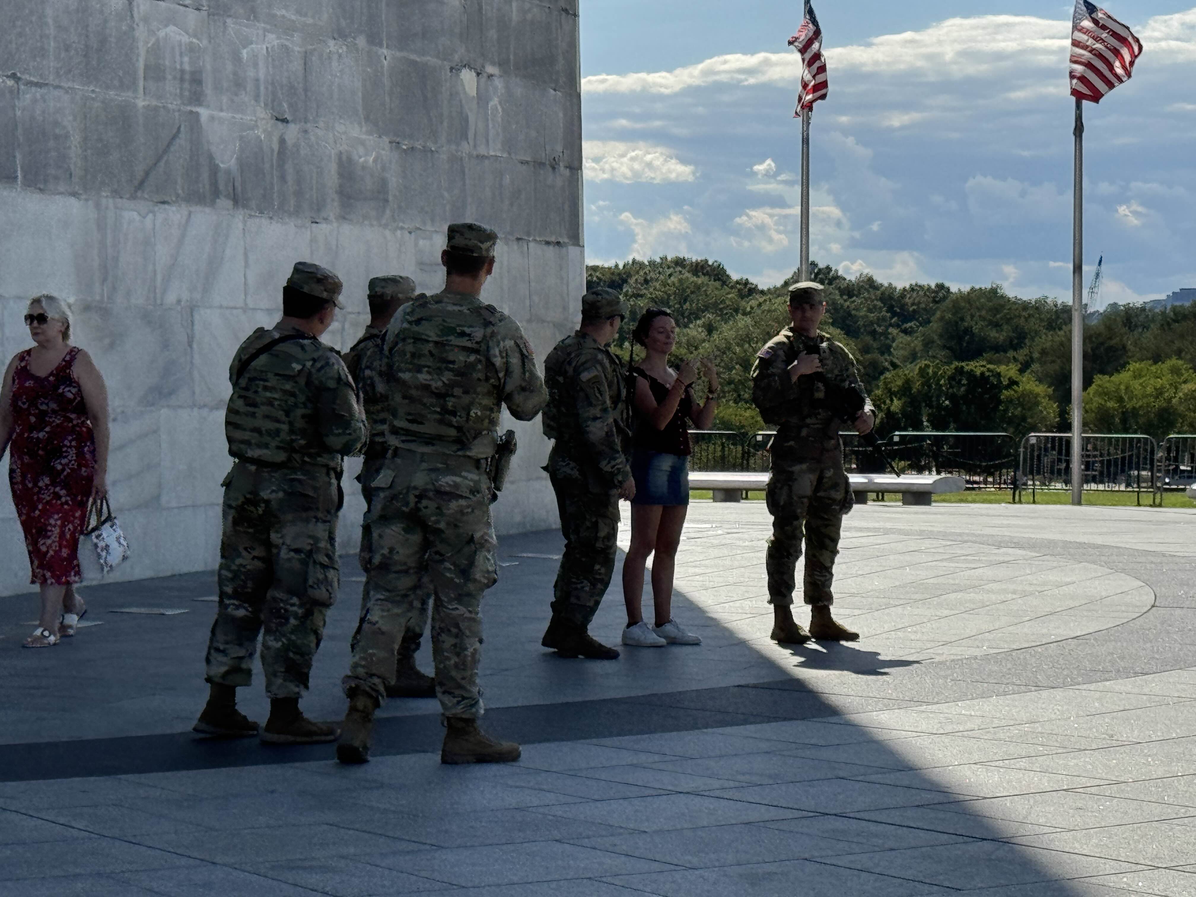 Soldiers from the West Virginia National Guard take a photo with a tourist at the Washington Monument on Tuesday, Aug. 26. ZFJ/Alvin Wu