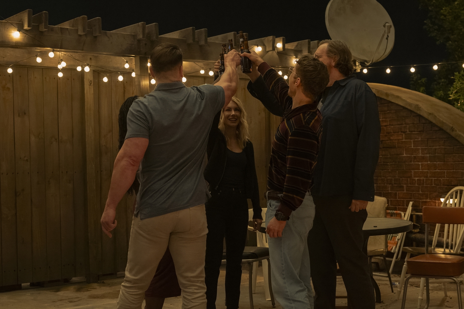 The 11th Street Kids (Freddie Stroma, Steve Agee, Jennifer Holland, and Danielle Brooks hidden behind John Cena) partying on a rooftop. HBO MAX/Erin Sintoes